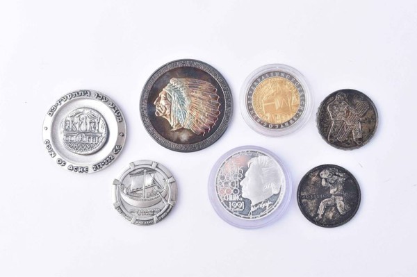 A group of silver coins and medals